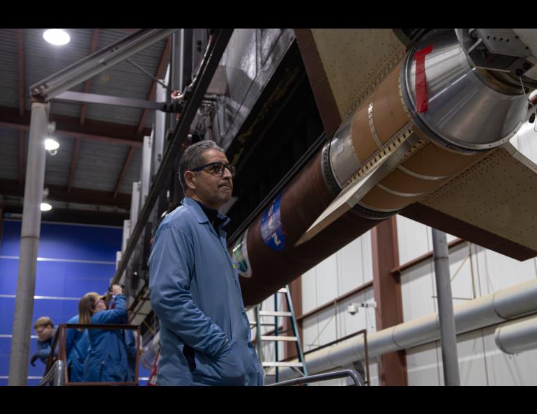 Principal investigator Mehdi Benna stands by the rocket assembled for his experiment. Photo by Danielle Johnson/NASA Wallops Flight Facility