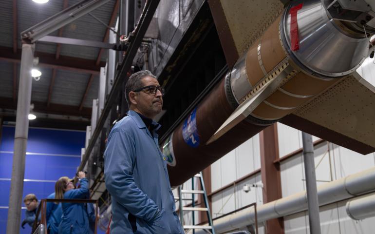 Principal investigator Mehdi Benna stands by the rocket assembled for his experiment. Photo by Danielle Johnson/NASA Wallops Flight Facility