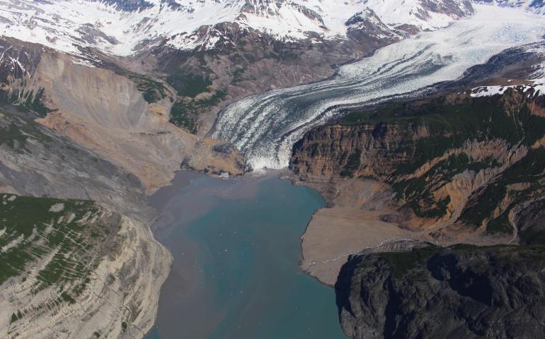 The debris field from an October 2015 landslide extends over the toe of the Tyndall Glacier and into Taan Fjord in spring 2016. Photo by Chris Larsen.