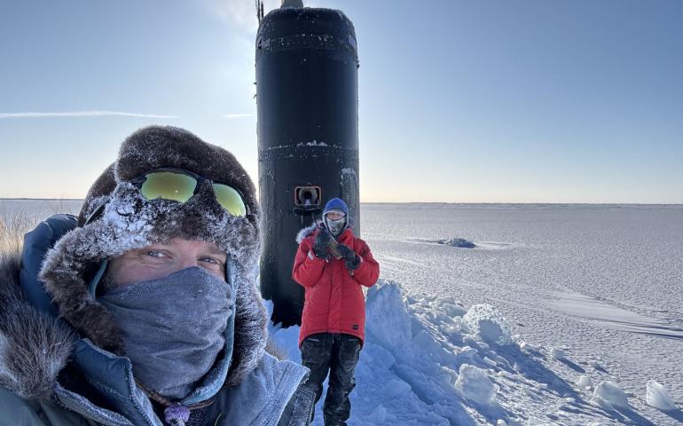 Research professor Andy Mahoney of the University of Alaska Fairbanks Geophysical Institute, left, stands near the USS Hampton’s sail during Operation Ice Camp in March 2024. A civilian employee with the Navy’s Arctic Submarine Lab stands in front of the sail. Photo courtesy of Andy Mahoney
